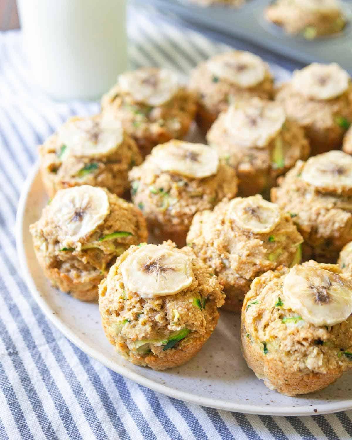 These banana zucchini muffins are made with half oat flour and half whole wheat white flour for a healthy bite-sized end of summer snack and perfect for back to school lunch boxes. These banana zucchini muffins are made with half oat flour and half whole wheat white flour for a healthy bite-sized end of summer snack and perfect for back to school lunch boxes.