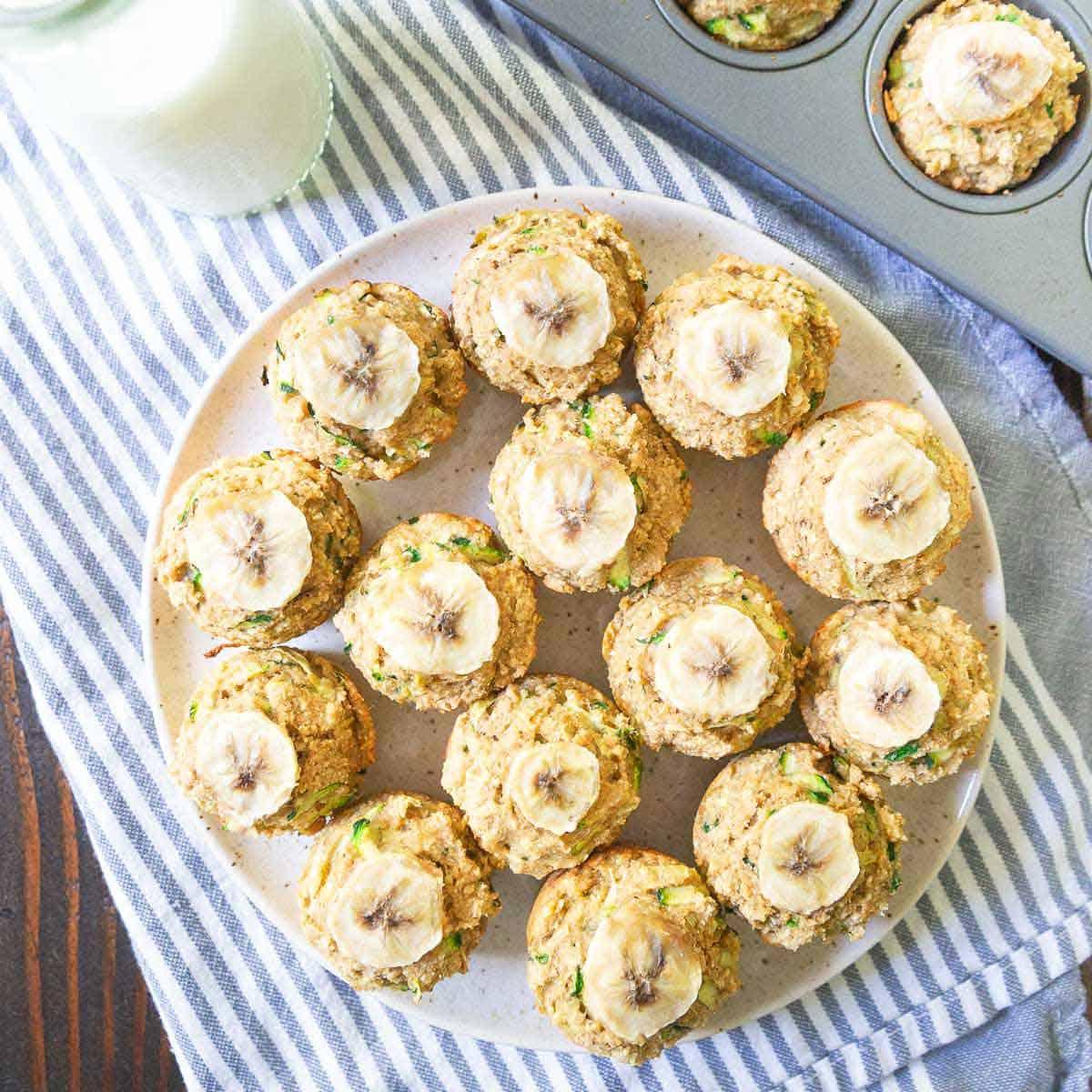 This banana zucchini muffin recipe is super simple and makes a batch of 20 mini-muffins for snacking all week long. This banana zucchini muffin recipe is super simple and makes a batch of 20 mini-muffins for snacking all week long.