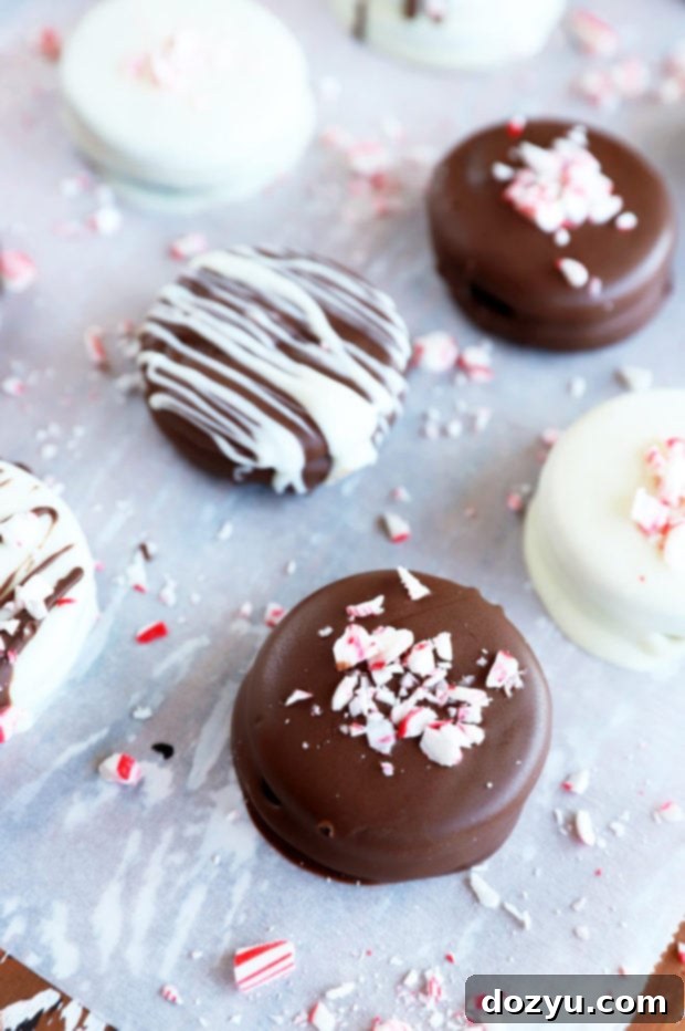 Effortless Chocolate Oreo Treats 2 Chocolate covered oreos on parchment paper image, featuring a variety of decorated cookies on a festive background, perfect for holiday gatherings.
