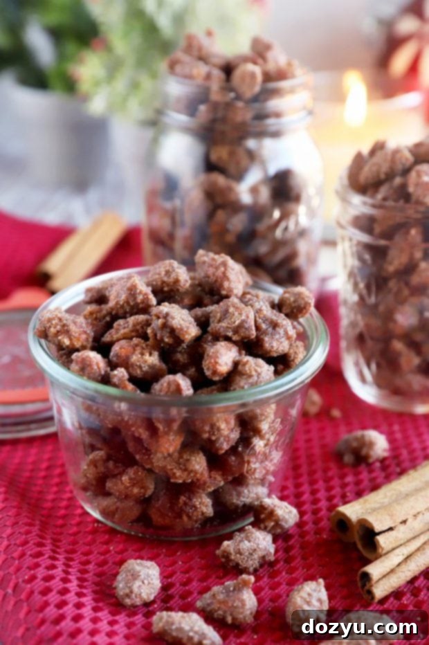 Slow Cooker Candied Cinnamon Almonds 6 Close-up of freshly made candied cinnamon almonds spread on a baking sheet to cool, with individual nuts visible.