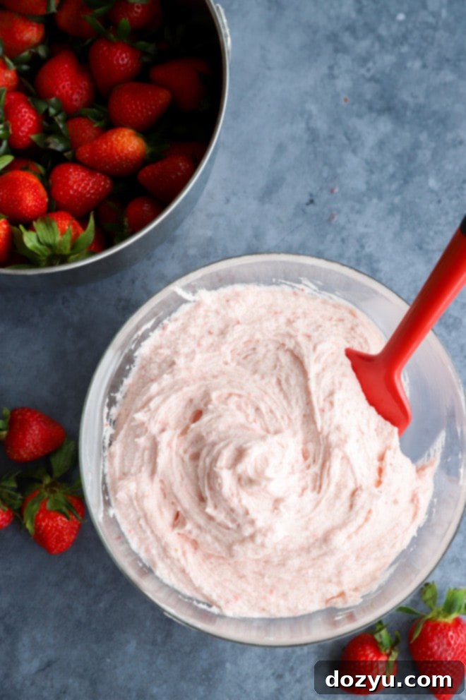 Luscious Chocolate Strawberry Cake 6 Strawberry buttercream frosting in a bowl with fresh strawberries image
