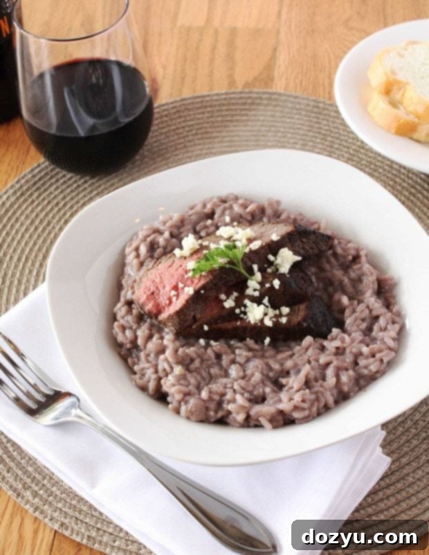 Decadent Red Wine Risotto with Steak and Blue Cheese 2 Close-up of a spoon scooping creamy red wine risotto, showing its rich texture and a hint of steak.