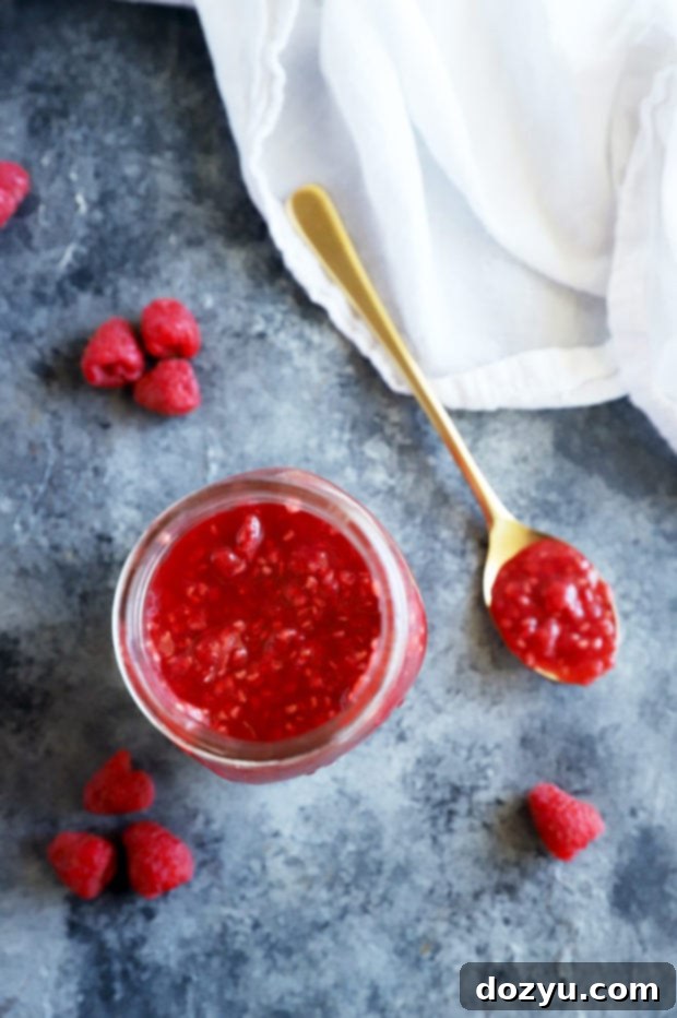 Ruby Raspberry Reduction 4 Overhead image of raspberry sauce on spoon and in jar