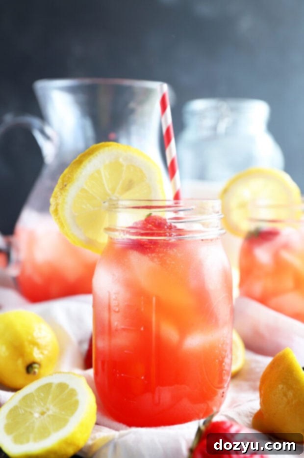 Refreshing Strawberry Vodka Lemonade 2 A refreshing glass of homemade Vodka Strawberry Lemonade garnished with fresh berries and lemon slices, perfect for summer.