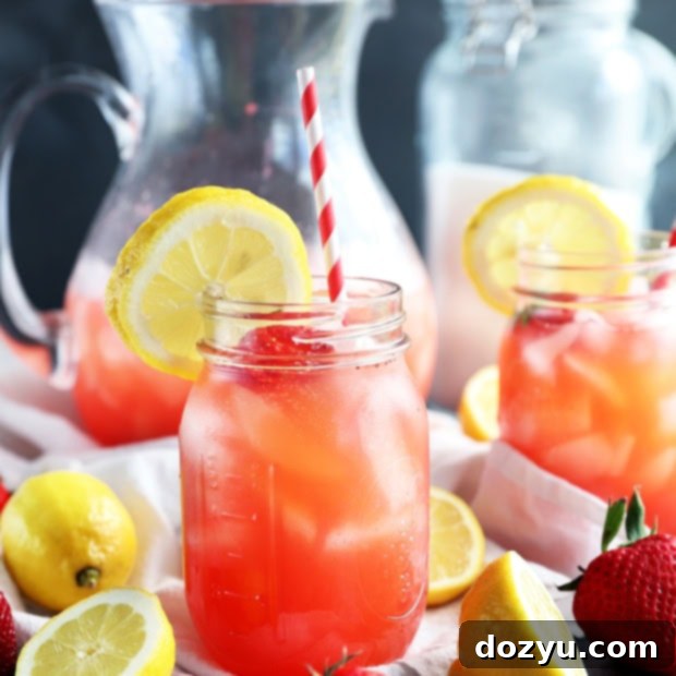 Refreshing Strawberry Vodka Lemonade 13 Vodka Strawberry Lemonade cocktail in a mason jar with a straw and garnish.
