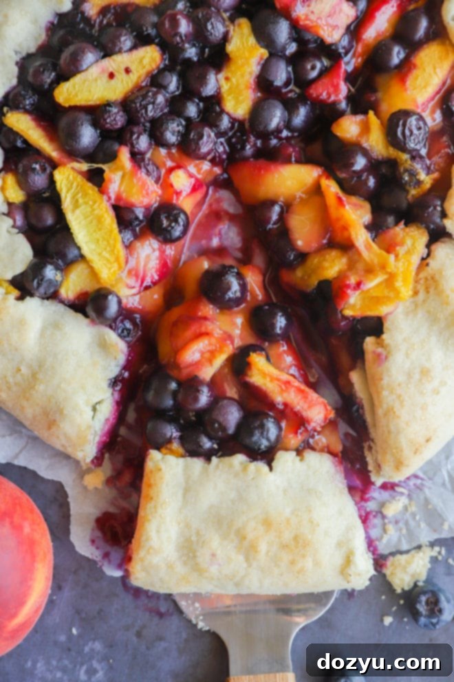 Rustic Peach Blueberry Galette 4 Slice of a fruit french dessert picture, showing the fruit filling and rustic crust
