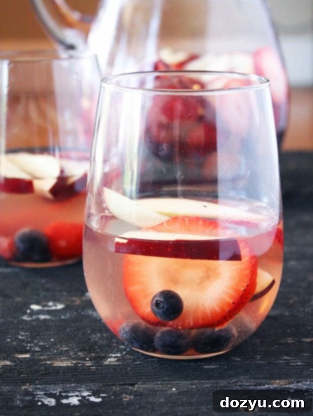 Stars and Stripes Sangria 2 Red, White & Blue Sangria in a pitcher with fresh fruit