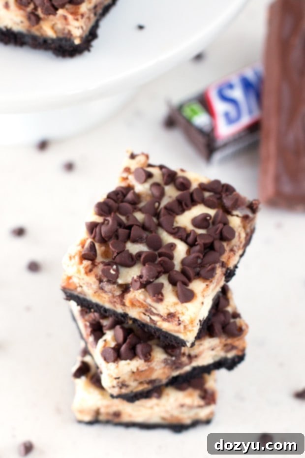 Decadent Snickers Caramel Cheesecake Bars 2 Decadent Snickers Caramel Cheesecake Bars on a serving platter