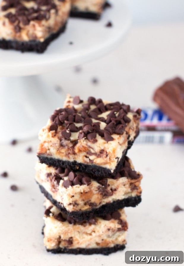 Decadent Snickers Caramel Cheesecake Bars 4 Stack of freshly baked Snickers Caramel Cheesecake Bars ready to be served