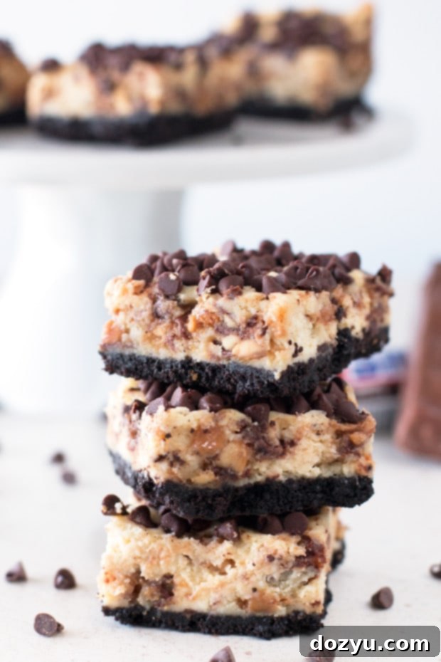 Decadent Snickers Caramel Cheesecake Bars 5 Freshly cut Snickers Caramel Cheesecake Bars on a wire rack
