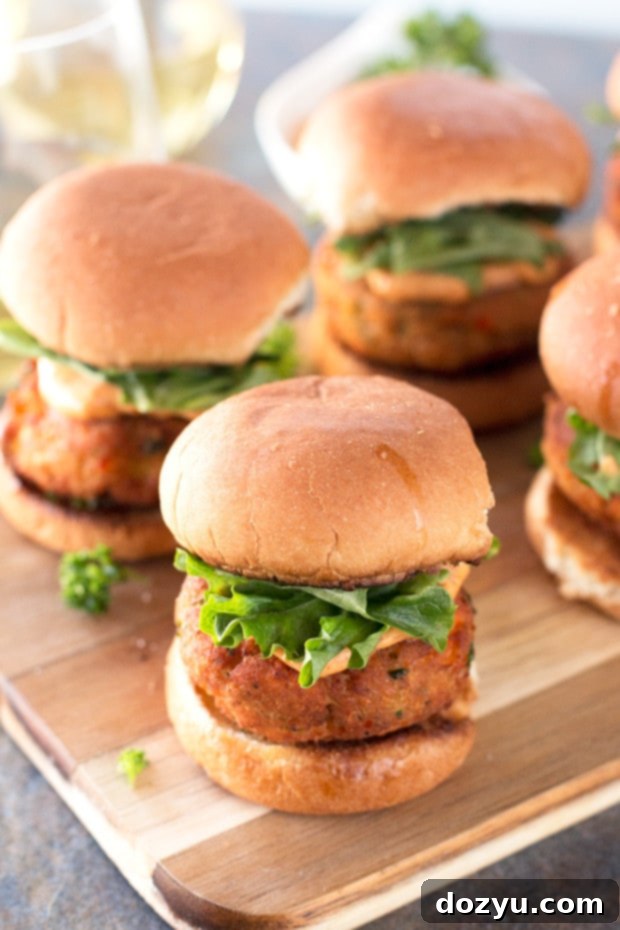 An appetizing display of Salmon Cake Sliders with Spicy Mayo, ready for serving