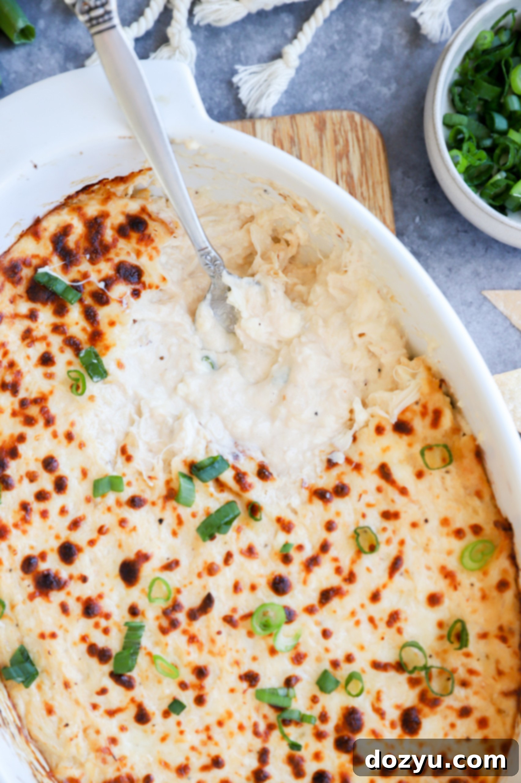 Creamy Crab Rangoon Dip with Crispy Wonton Dippers 3 Spoon in crab rangoon dip in casserole dish picture
