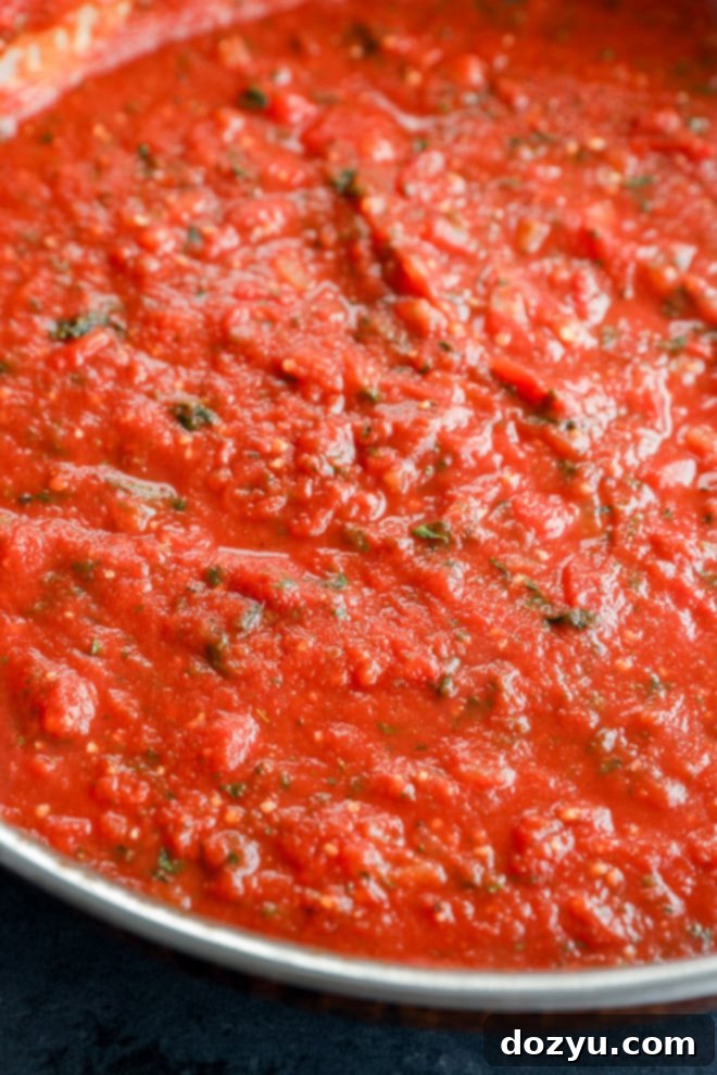 simmering homemade tomato sauce in a stainless steel skillet