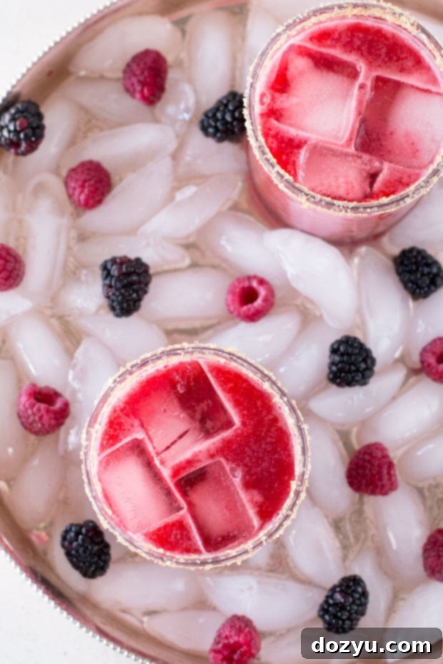 A close-up of a refreshing Mixed Berry Margarita with a vibrant red hue, showcasing the fresh berries.