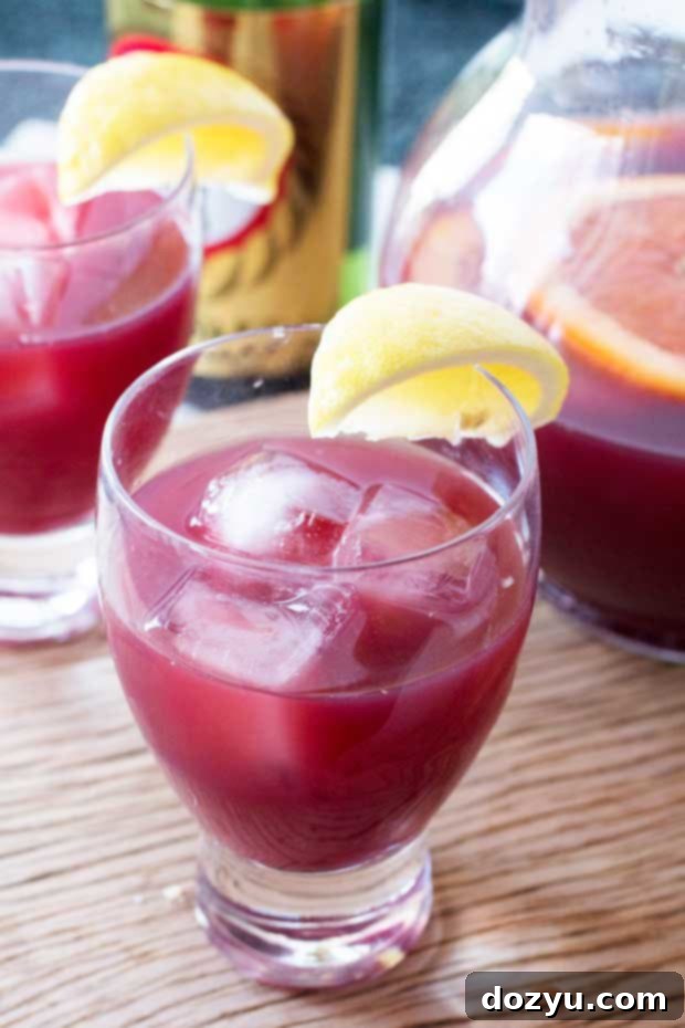 Refreshing Sake Sangria 2 Vibrant Sake Sangria in a glass with orange and lime slices, ready for a backyard BBQ.