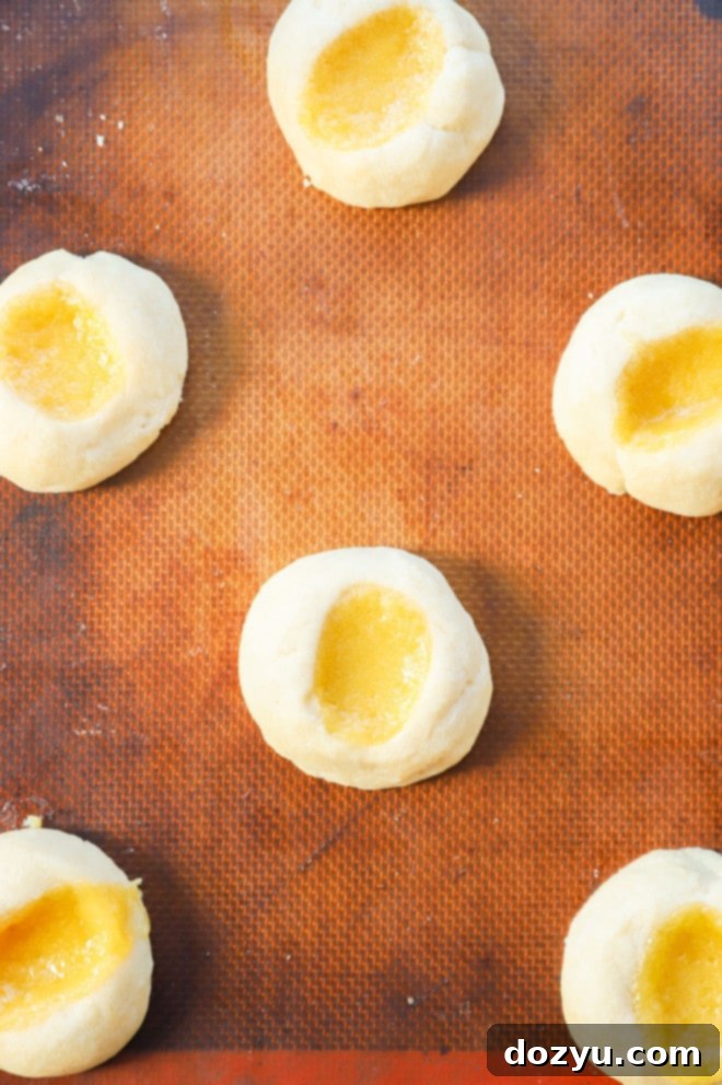 Lemon Curd Meringue Cookies 7 Lemon curd thumbprint cookies with indents ready for filling