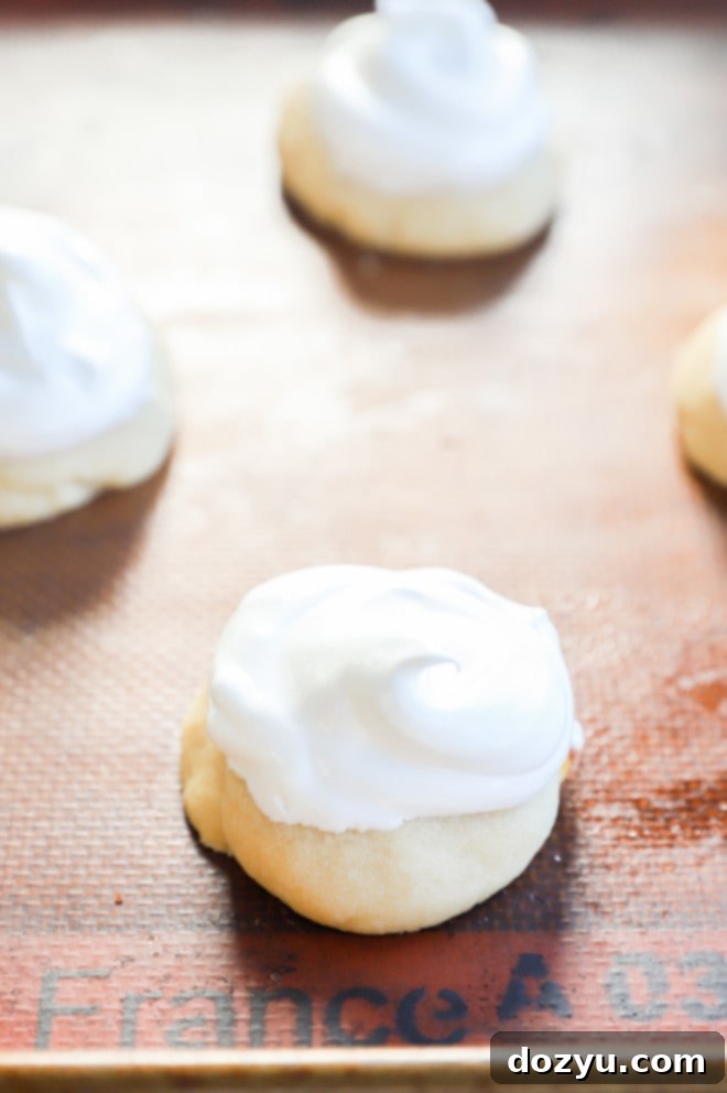 Lemon Curd Meringue Cookies 8 Meringue topping on cookies before baking in the oven for browning