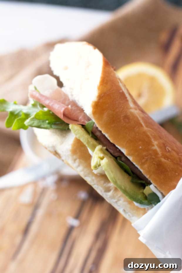 Blast Off Bite 4 Close-up of the Rocket Sandwich, showing fresh avocado slices and prosciutto