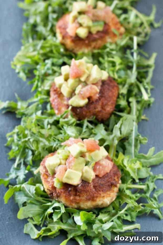 Crispy Crab Cakes, Zesty Avocado-Grapefruit Salsa 2 Crispy Crab Cakes with Avocado Grapefruit Salsa on a bed of greens