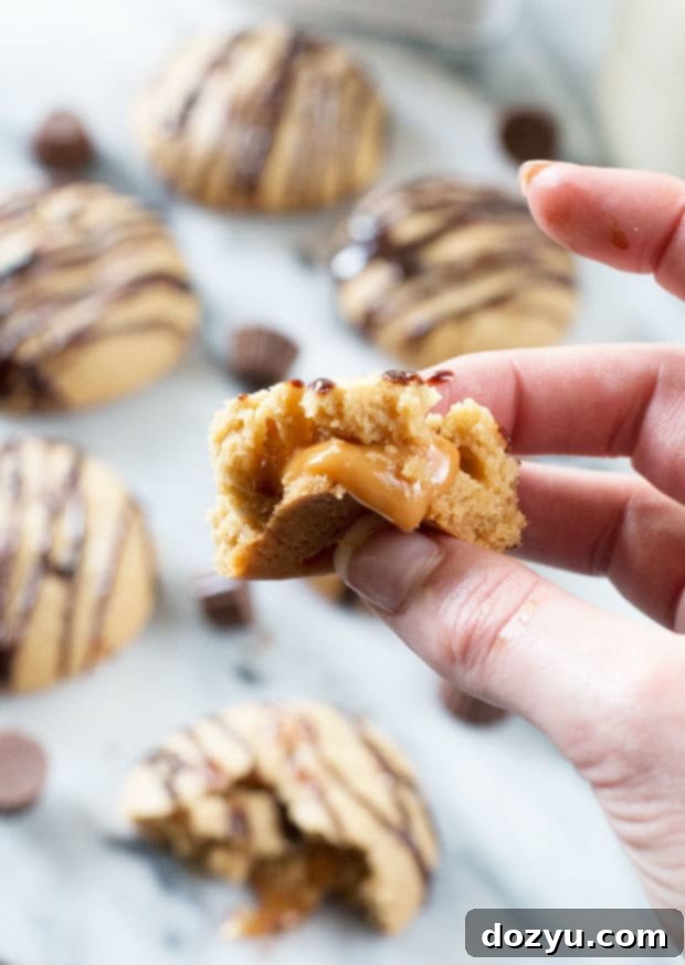 Molten Caramel Peanut Butter Cookies 3 Freshly baked Caramel Stuffed Peanut Butter Cookies on a cooling rack