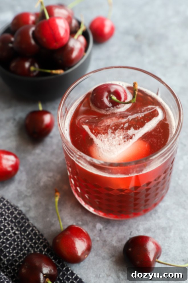 Velvet Cherry Amaretto Sour 2 Fresh cherry cocktail in glass with fruit image