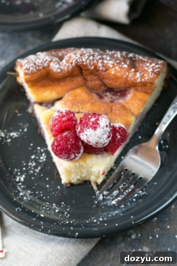 Luscious Raspberry Lemon Ricotta Cheesecake 5 A perfectly sliced piece of Raspberry Lemon Ricotta Cheesecake on a plate, ready to be enjoyed.