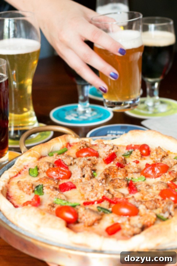 Friends enjoying a homemade pizza and beer tasting party setup with a spread of craft beers and fresh ingredients.