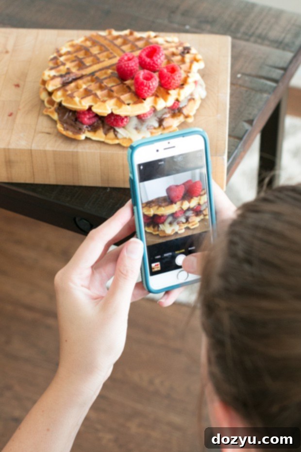 Step-by-step process of assembling Raspberry Nutella Brie Waffle Sandwiches, showing waffles, Nutella, brie, and raspberries