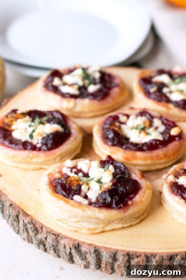 Sweet and Savory Cranberry Goat Cheese Tarts 3 Close-up of baked Cranberry Goat Cheese Tarts, garnished with fresh thyme