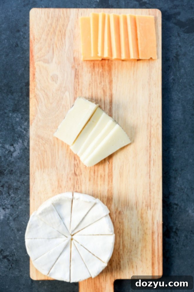 cheeses and small bowls arranged on a platter as the first step of building an easy charcuterie board