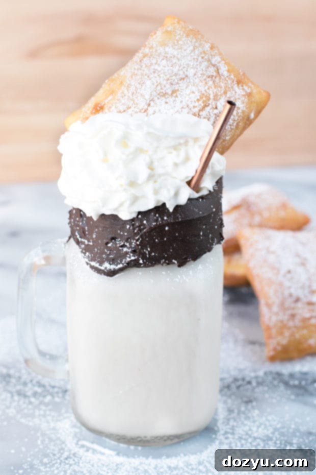 Spiked Beignet Coffee Shake 4 Beignet and Coffee Cocktail Shake in a tall glass with chocolate rim and whipped cream