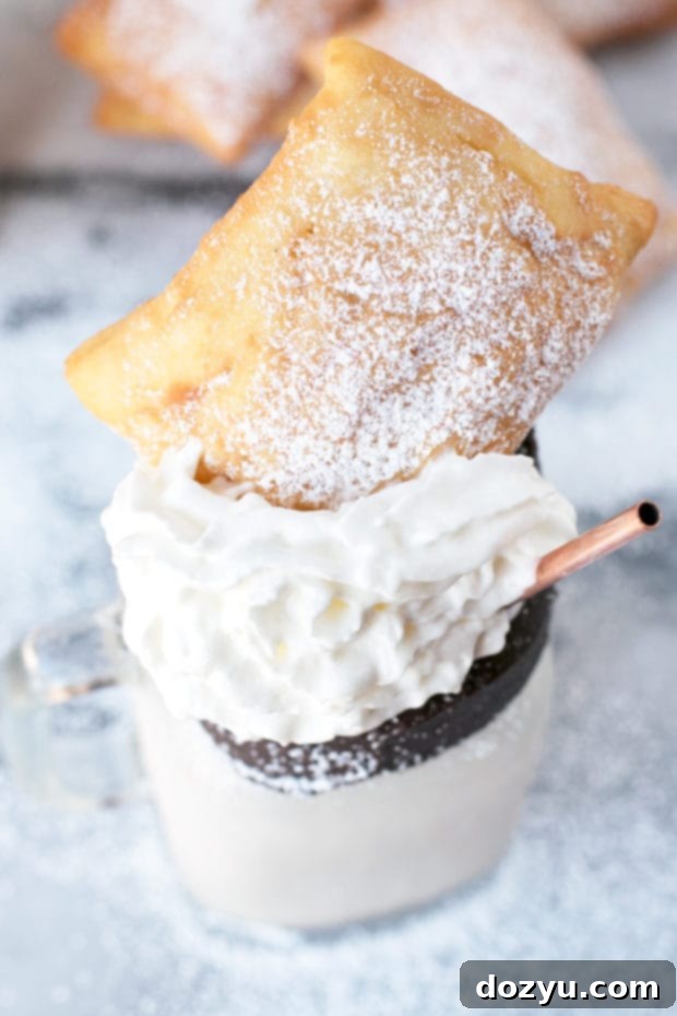 Spiked Beignet Coffee Shake 5 Hand holding a decadent Beignet and Coffee Cocktail Shake, ready to be enjoyed