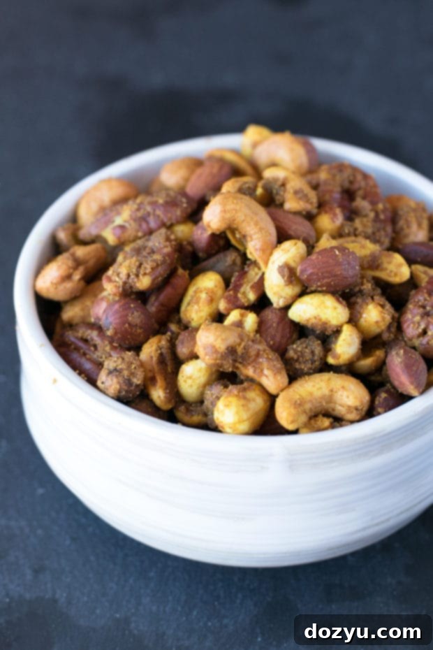Aromatic Curried Nut Blend 3 Close-up of Curried Nut Mix showing the vibrant spices and various nuts like cashews and almonds, highlighting its appeal as a gourmet snack.