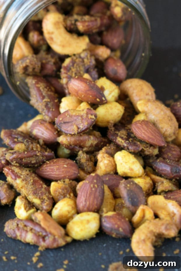 Aromatic Curried Nut Blend 4 A bowl of homemade Curried Nut Mix, an ideal healthy snack or party appetizer, seasoned with sweet and savory curry spices.