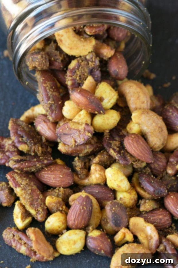 Aromatic Curried Nut Blend 6 Individual Curried Nut Mix pieces on a white surface, showcasing the detailed spice coating and inviting texture.