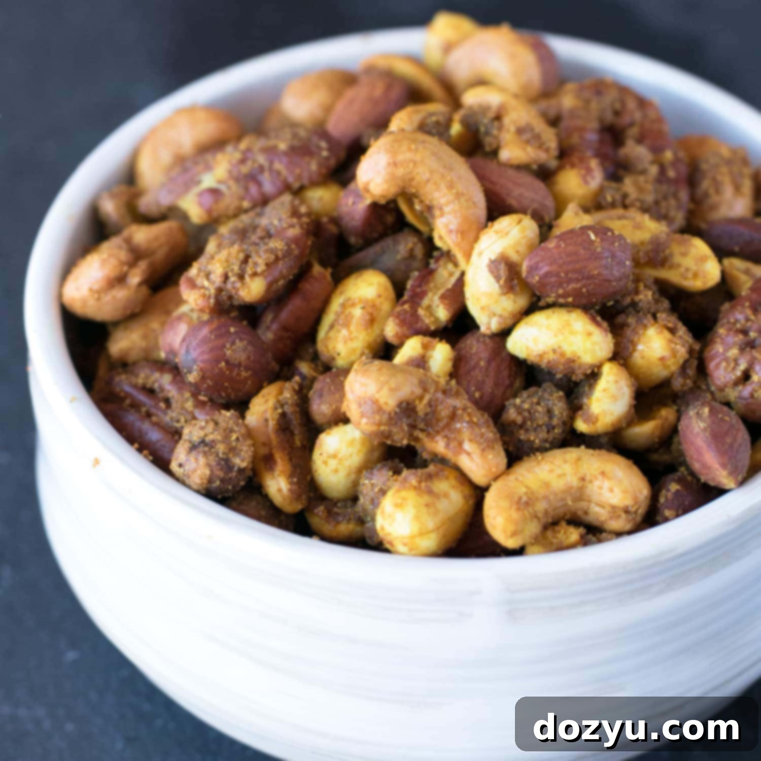 Aromatic Curried Nut Blend 7 Irresistible Curried Nut Mix thumbnail, showcasing its golden brown coating and variety of nuts. Ideal for a spicy and sweet homemade snack.