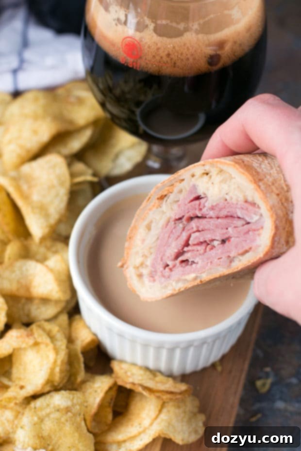 A hand holding an Irish Corned Beef Reuben Wrap, ready to be enjoyed