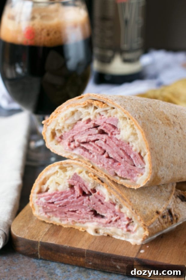 Two halves of an Irish Corned Beef Reuben Wrap, showing the rich filling and toasted cheese