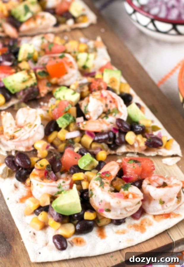 Zesty Southwestern Shrimp Flatbread 5 A Southwestern Shrimp Flatbread displayed on a rustic background, emphasizing its homemade appeal.