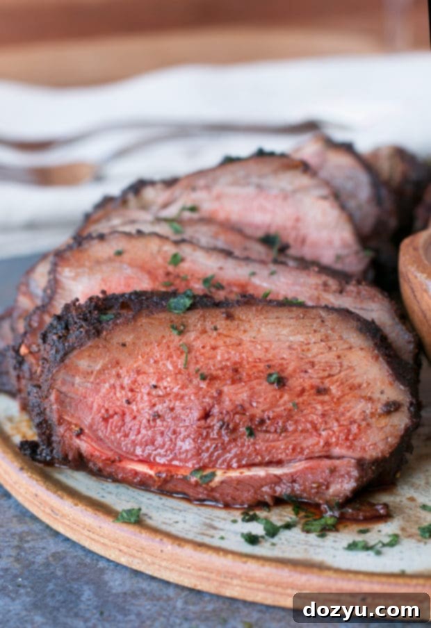 Succulent Ancho Chili Rubbed Leg of Lamb, grilled to perfection and ready for slicing, served with a cooling mint yogurt sauce.