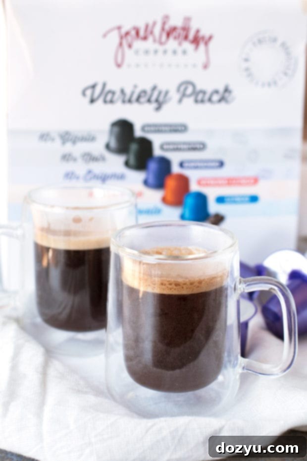 Chili Caramel Macchiato preparation: espresso being poured into a mug with homemade chili vanilla syrup at the bottom, creating beautiful layers.