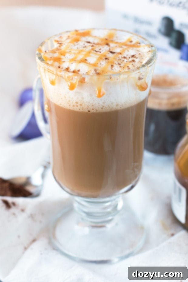 A single serving of a homemade Chili Caramel Macchiato in a stylish clear glass, garnished with a light sprinkle of chili powder, on a warm, inviting surface.
