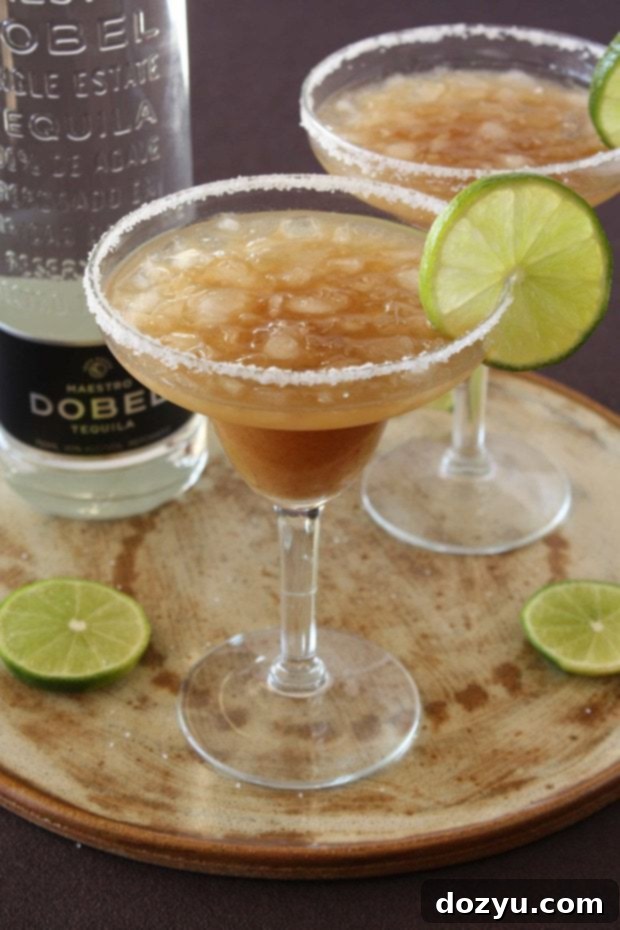 Maestro Dobel's Tangy Tamarind Margarita 2 Tamarind Margarita in a glass with Dobel Tequila bottle