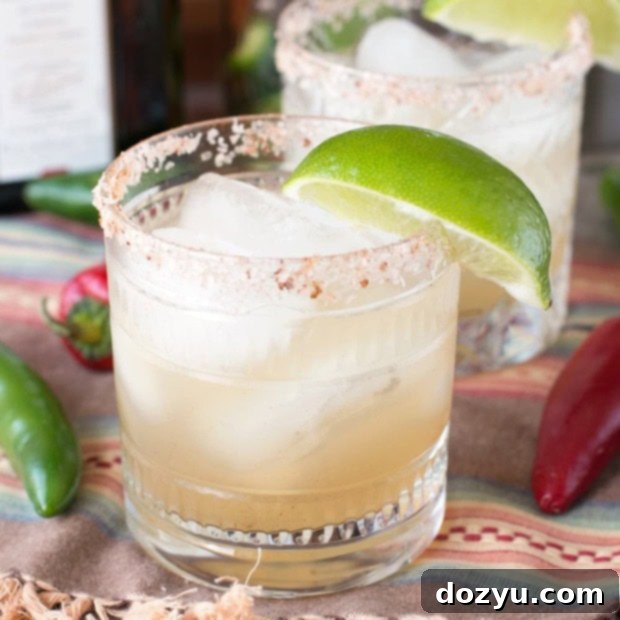 Zesty Heat Margarita 9 Chili Lime Margarita with a chili salt rim and lime wedge garnish