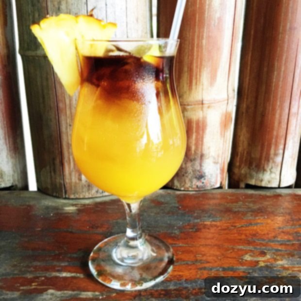 A lively bar scene at Tahiti Nui Cocktail Lounge in Kauai, with patrons enjoying drinks and live music in a tropical setting. Keywords: Tahiti Nui Kauai, best Mai Tai, North Shore bar, Kauai nightlife.