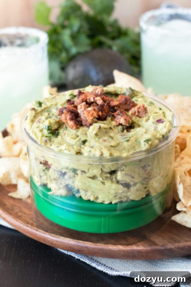 Close-up shot of Chipotle Chorizo Guacamole, showcasing its texture and savory ingredients.