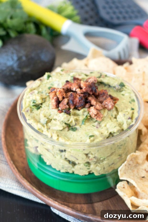 A 4-in-1 avocado tool next to a bowl of guacamole and avocados.