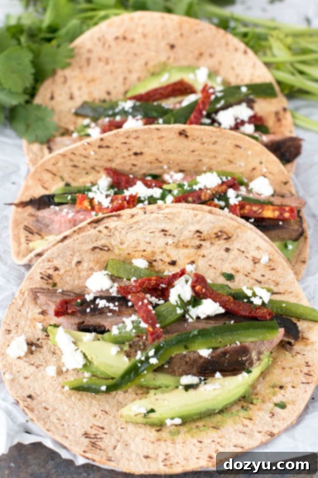 A fully assembled grilled flank steak poblano taco, garnished and ready to eat.