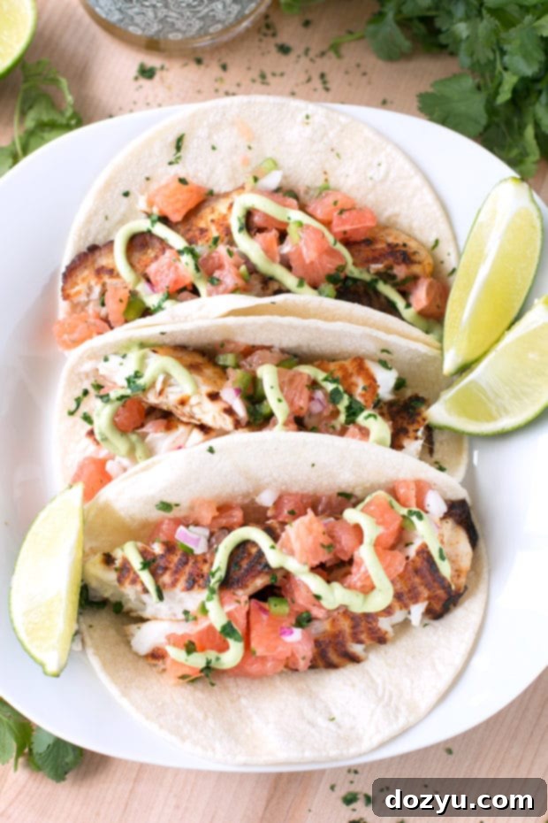 Beautifully plated Grilled Chile Vodka Fish Tacos with fresh salsa and crema.