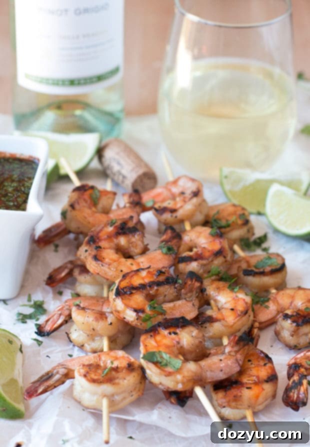 Zesty Mango Garlic Shrimp Skewers with Spicy Cilantro Dip 2 Perfectly grilled Mango Garlic Shrimp Skewers with Spicy Cilantro Dipping Sauce, ready for a summer party. Pairs wonderfully with Cavit Wines. | cakenknife.com #21andup @CavitWines